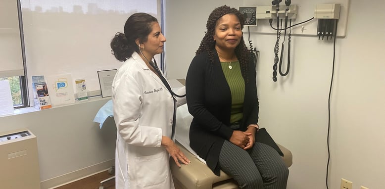 Dr. Shafai, holistic primary care doctor in McLean, VA, listening to patient with stethoscope