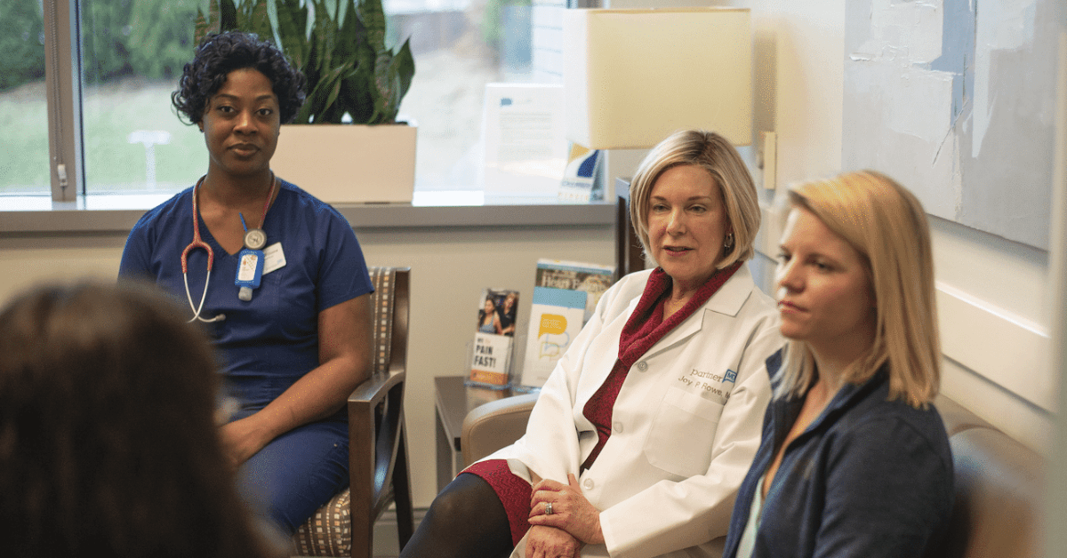 Team of healthcare professionals talking with patient