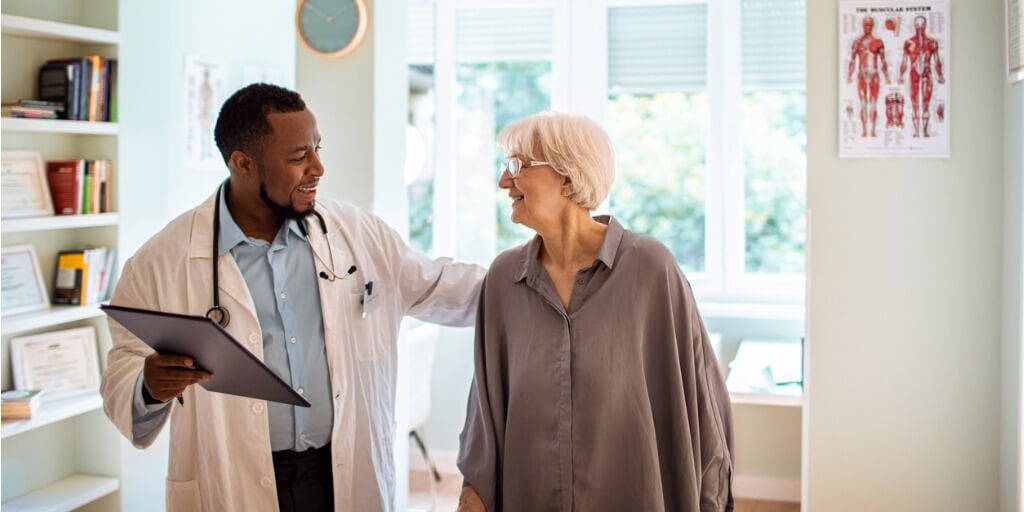 Male physician talking with patient