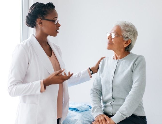Female physician talking to one of her patients. 