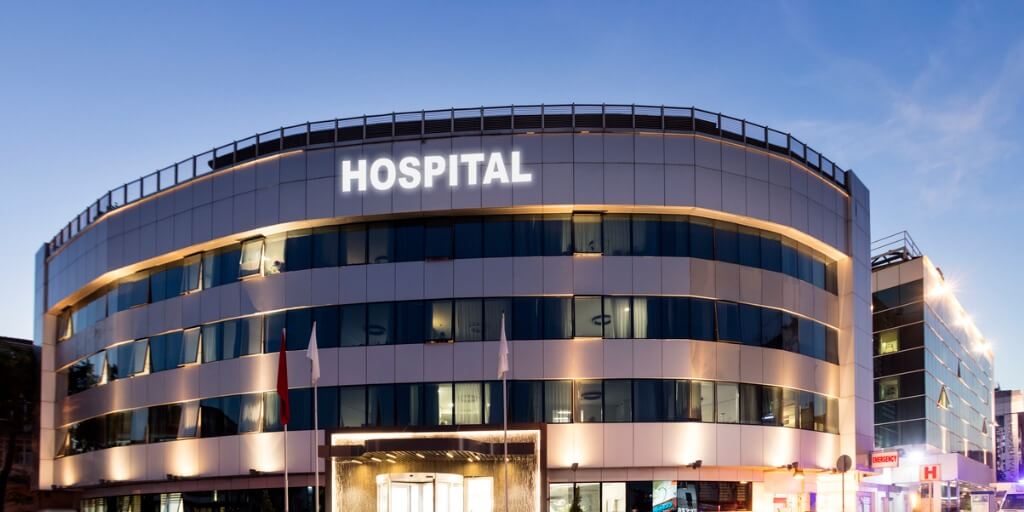 Outside of a hospital building in the early evening