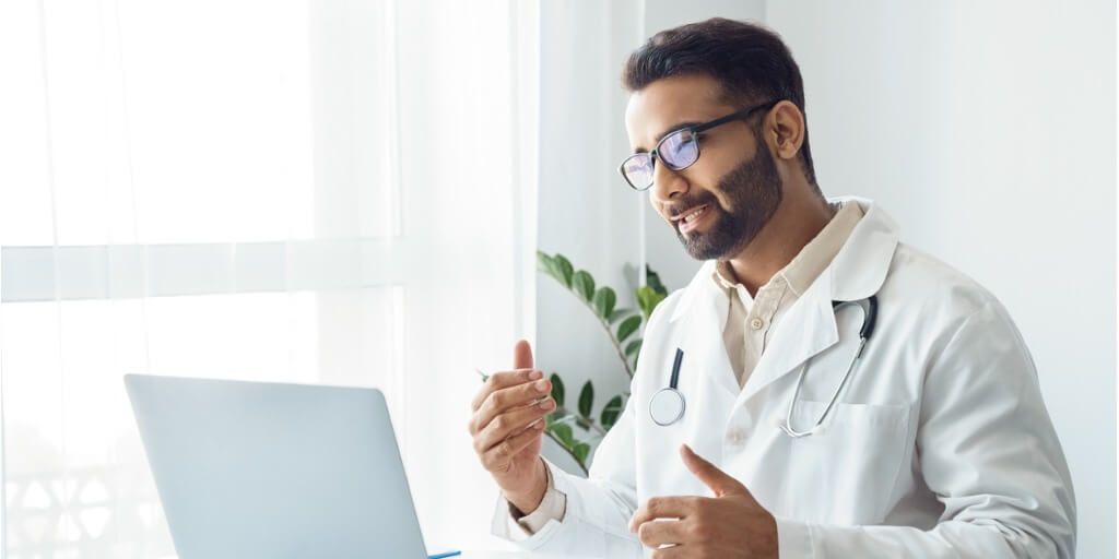 Primary care doctor talking to patient via the computer