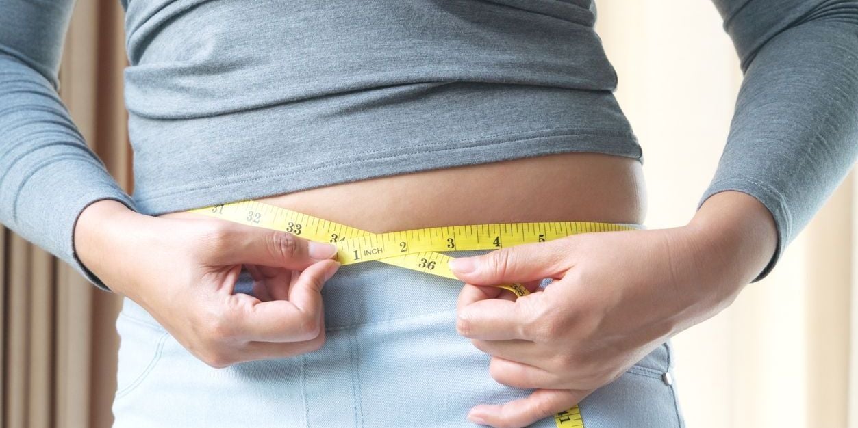 Woman measuring waist