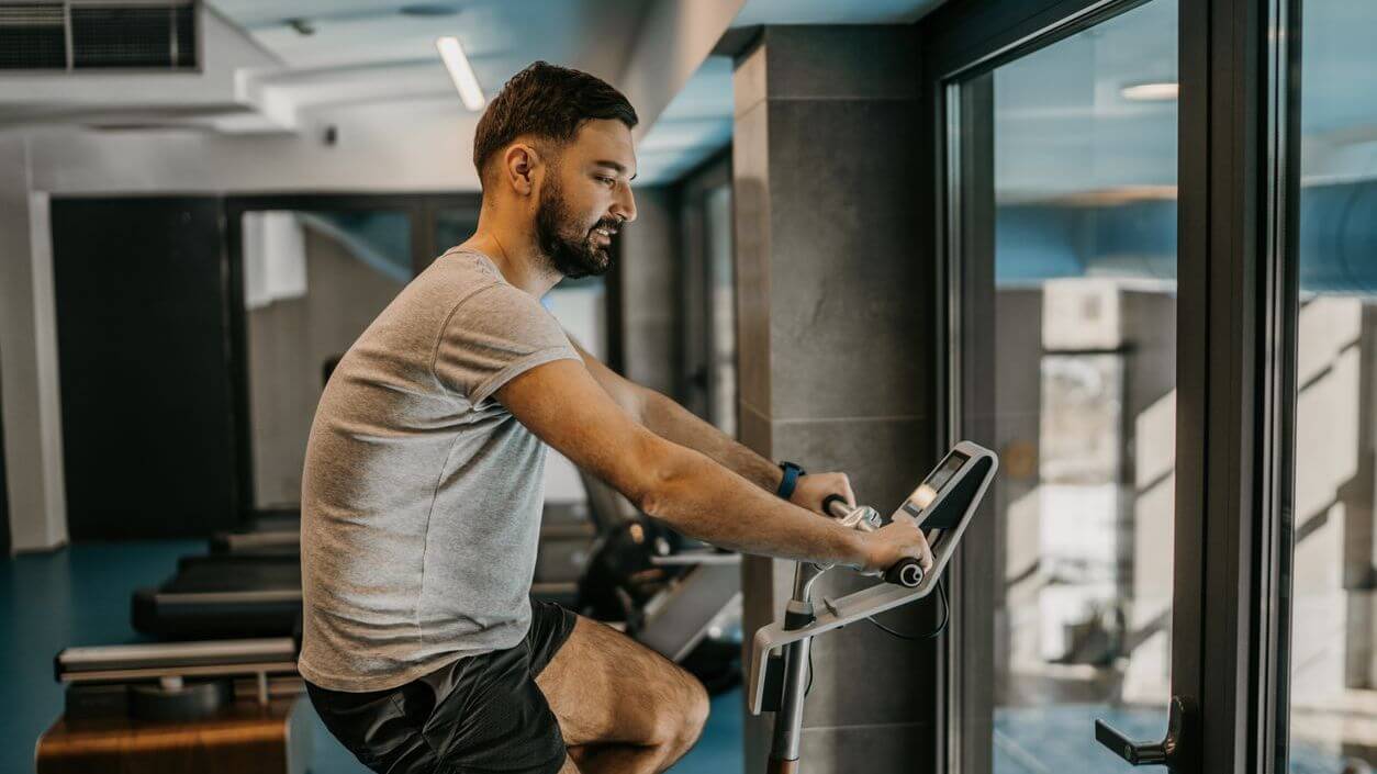 Man on an exercise bike while at a hotel