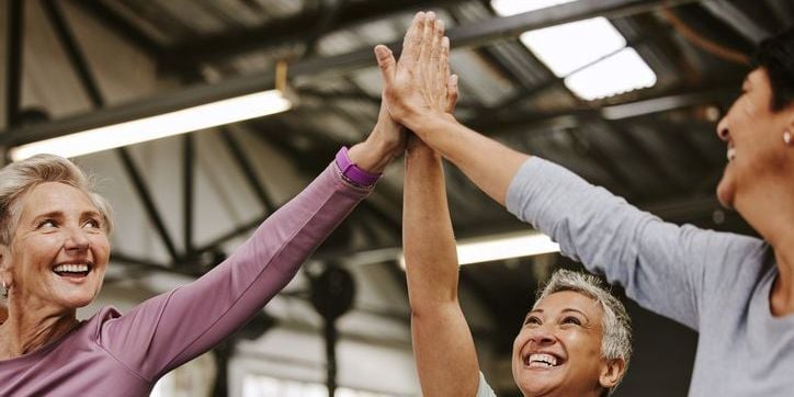 High fiving at a gym