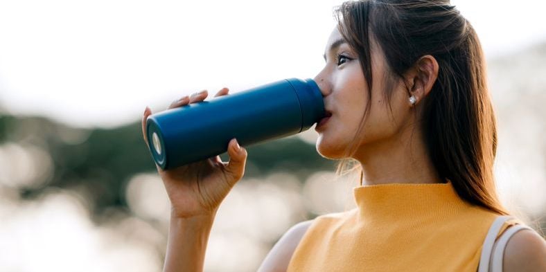 Woman drinking from a water bottle
