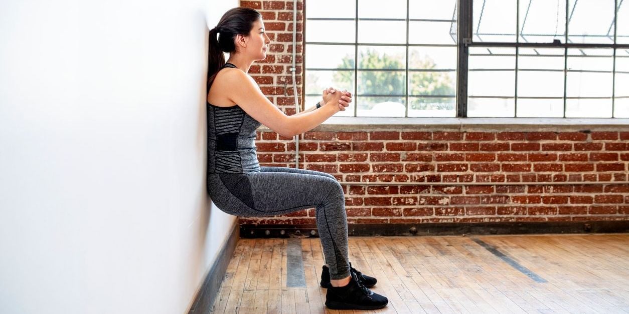 Woman doing wall sit.