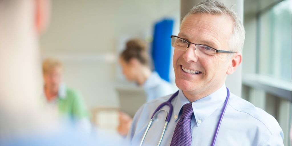 Male concierge doctor chatting with patient