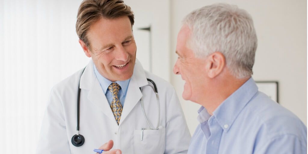 concierge doctor talking with male patient