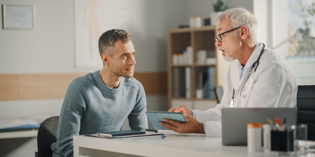 Middle-aged man talking to concierge doctor