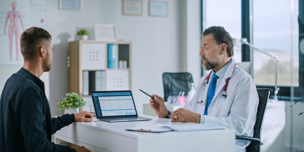 Male patient talking to male concierge doctor. 