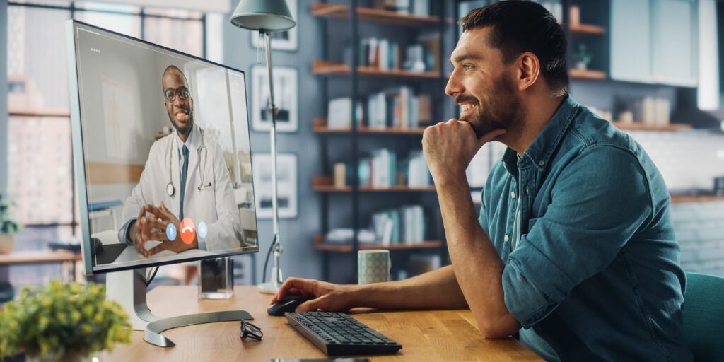 Man talking to doctor over computer