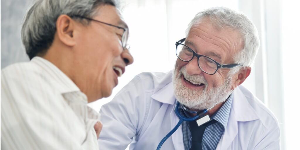 male concierge doctor laughing with patient