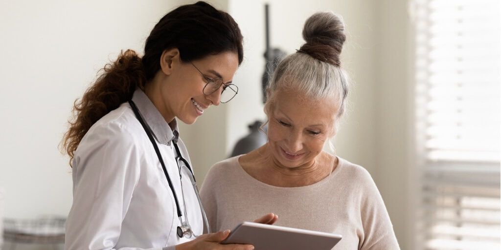 Female internist chatting with female patient