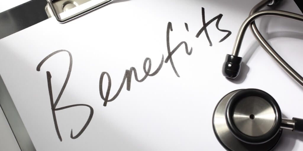 Stethoscope laying on a piece of paper with "benefits" written in cursive