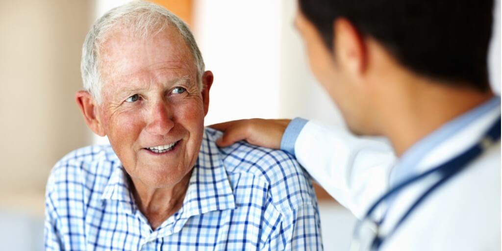 Older man talking to his physician