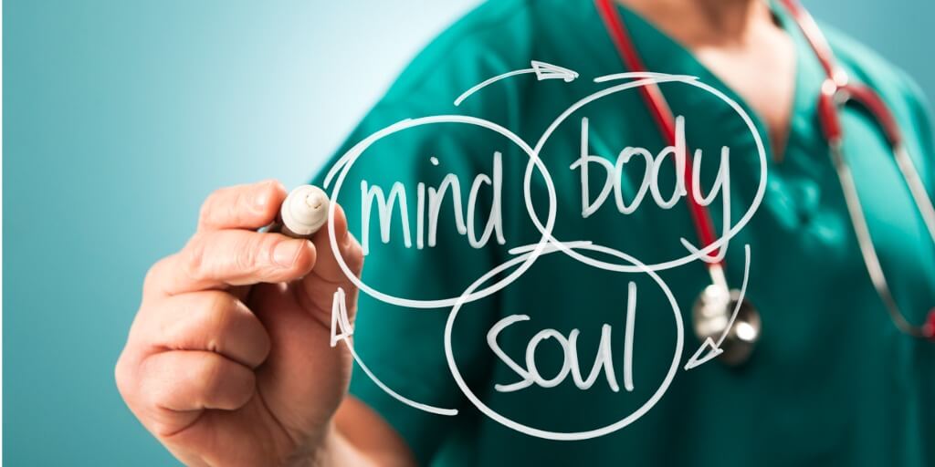 Holistic doctor writing on glass mind body and soul