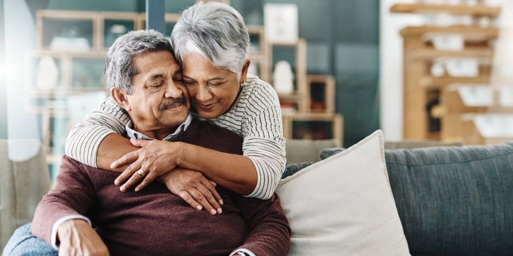 Older couple at home hugging