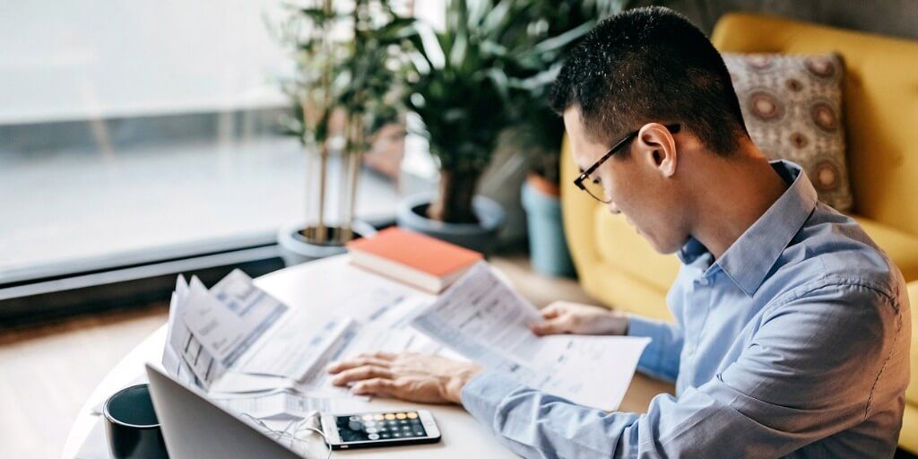 Young male looking over contracts and documents. 