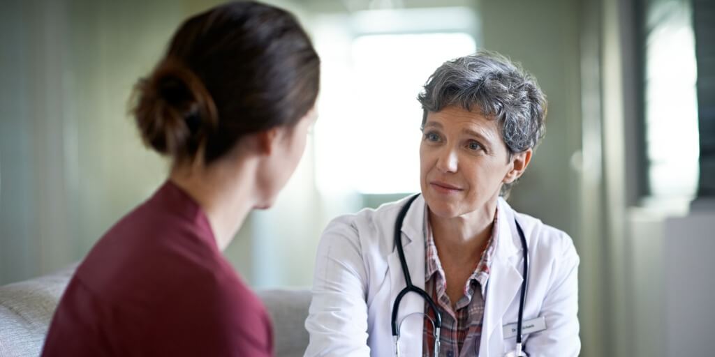 female doctor talking with patient during physical