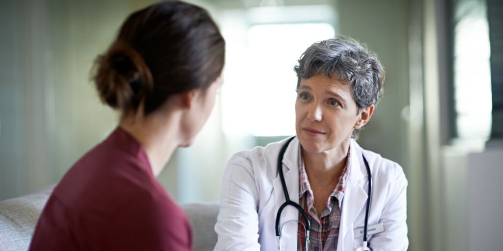 female doctor talking with patient during physical