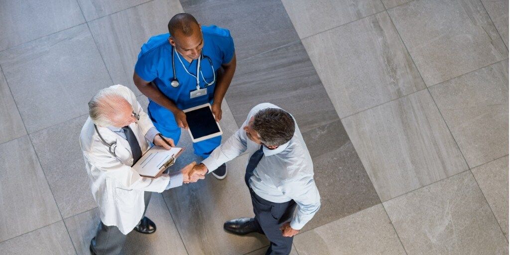 Concierge physician shaking hands with patient. 