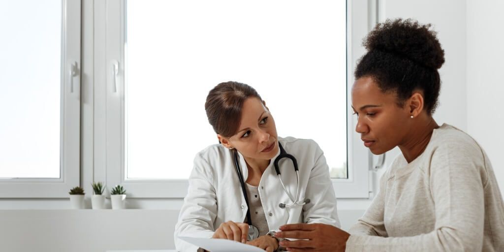 Woman talking with physician