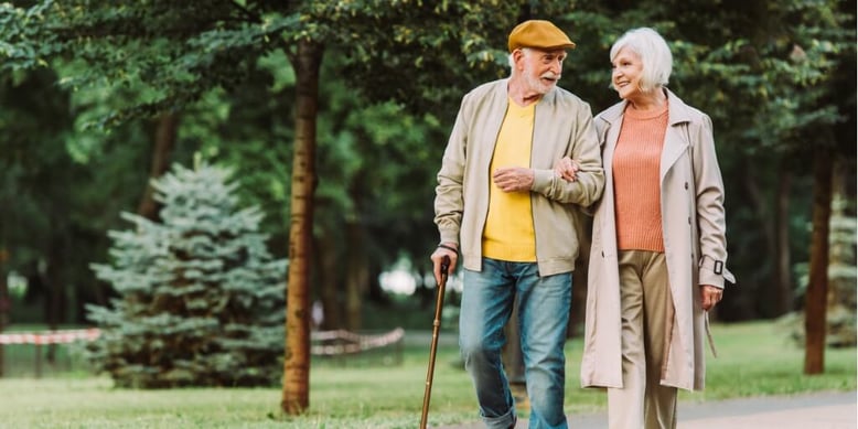Elderly couple walking together in a park