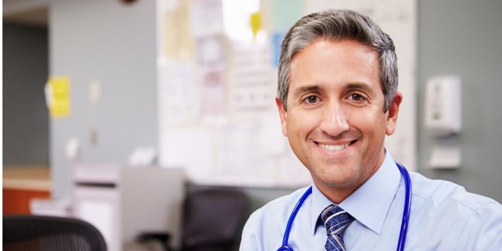 Male concierge doctor smiling at camera