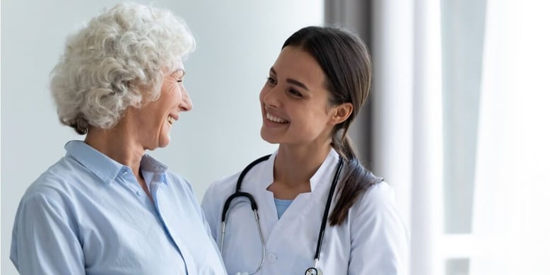 Young female concierge doctor talking with female patient