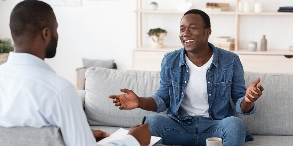 Young male patient talking with physician. 