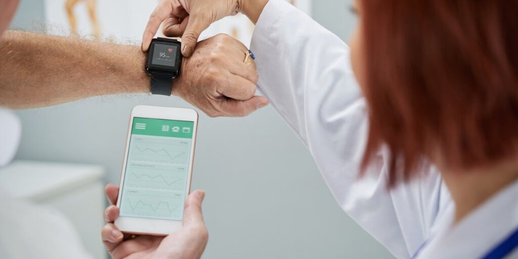 Physician explaining wearable device data to patient