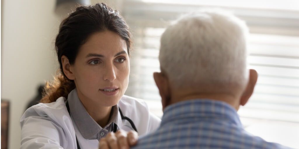 Female physician with older male patient