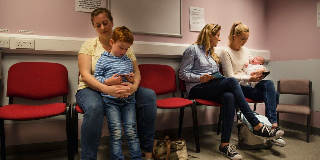 Mother with young boy waiting in lobby at the doctor's office. 