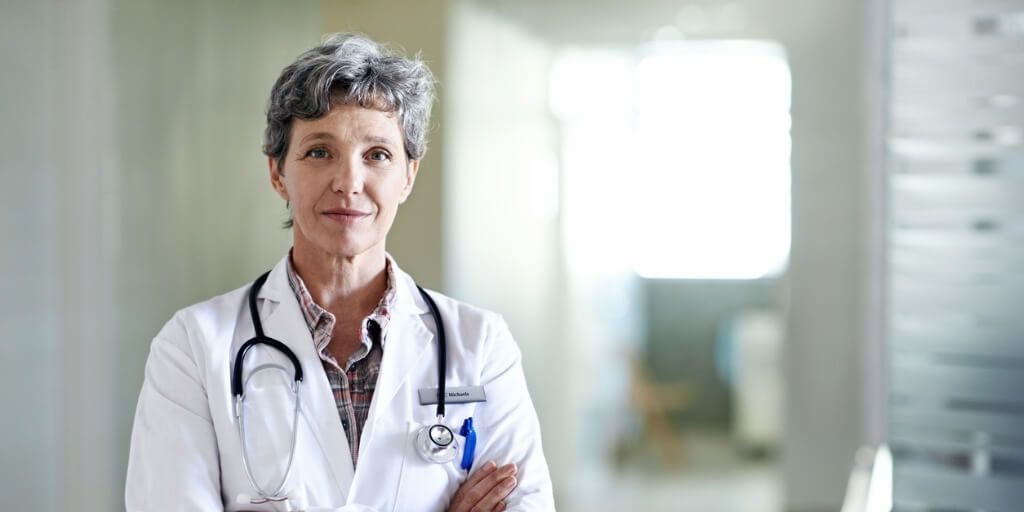 Female concierge doctor with arms crossed looking at camera