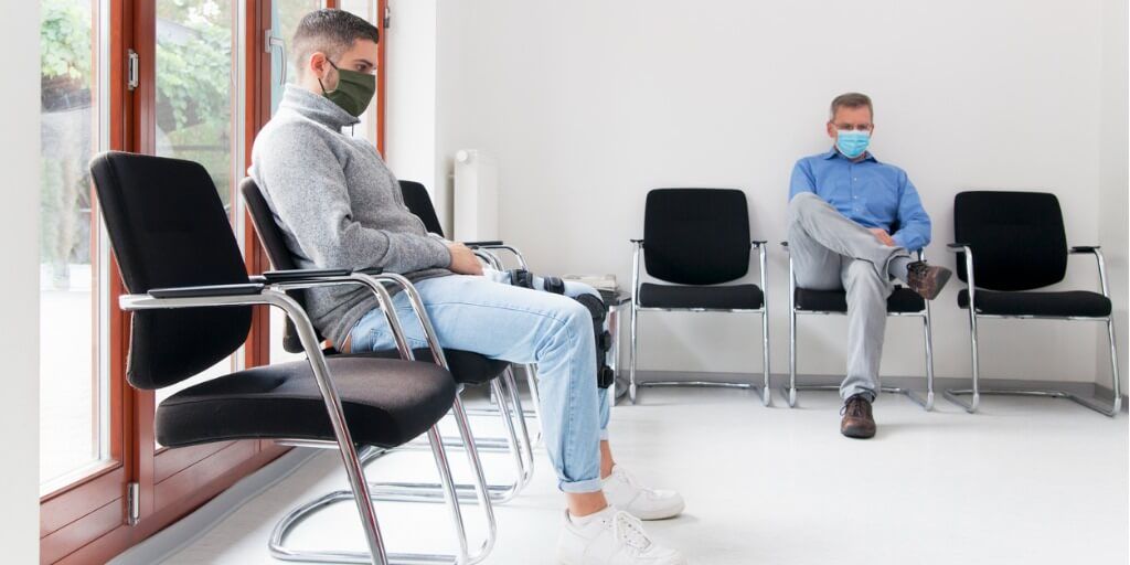 two men in a waiting room at the doctor's office