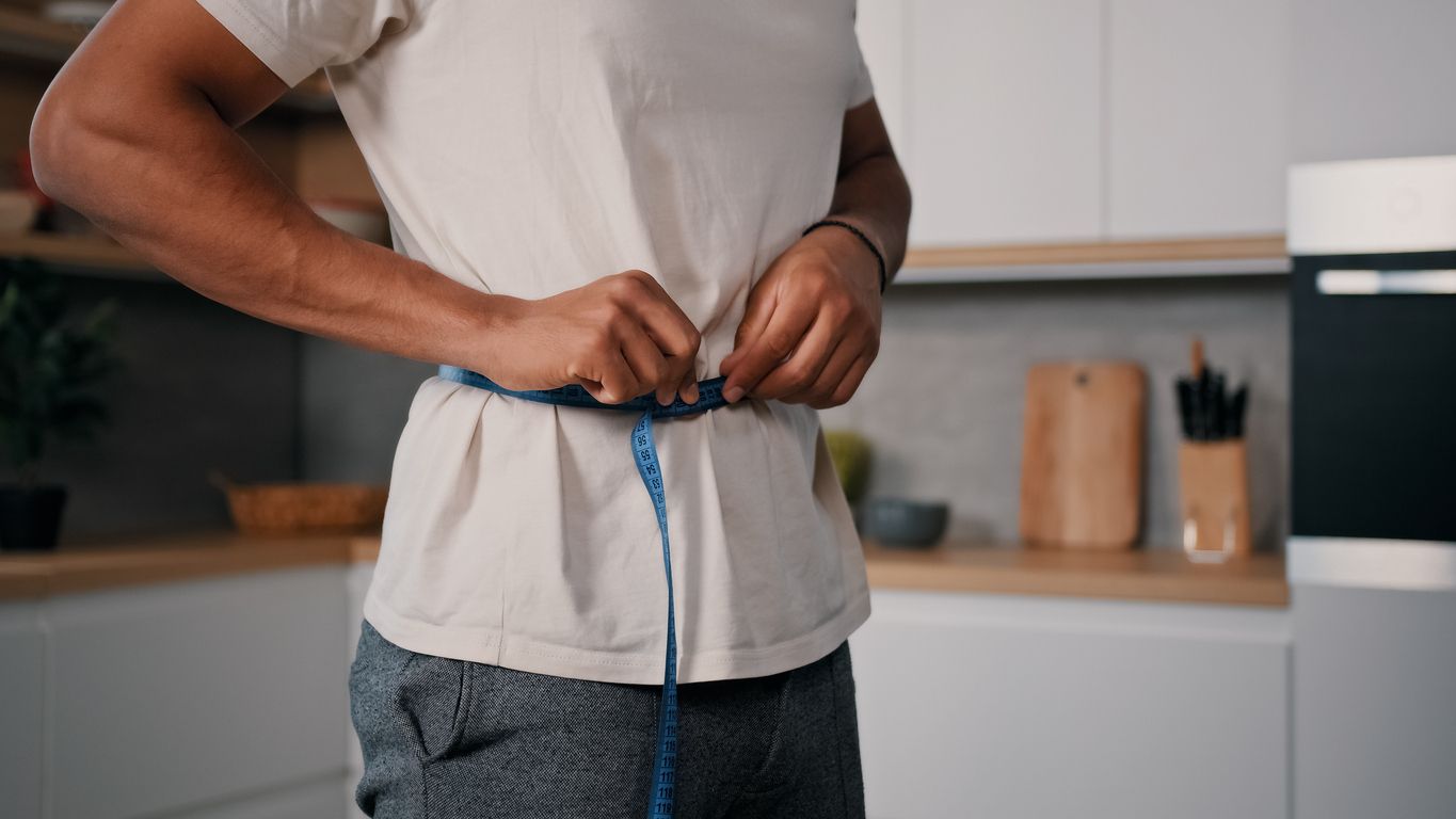 Man taking measurements of his weight.