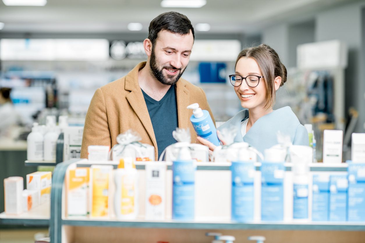 Couple shopping for sunscreen at the grocery store.