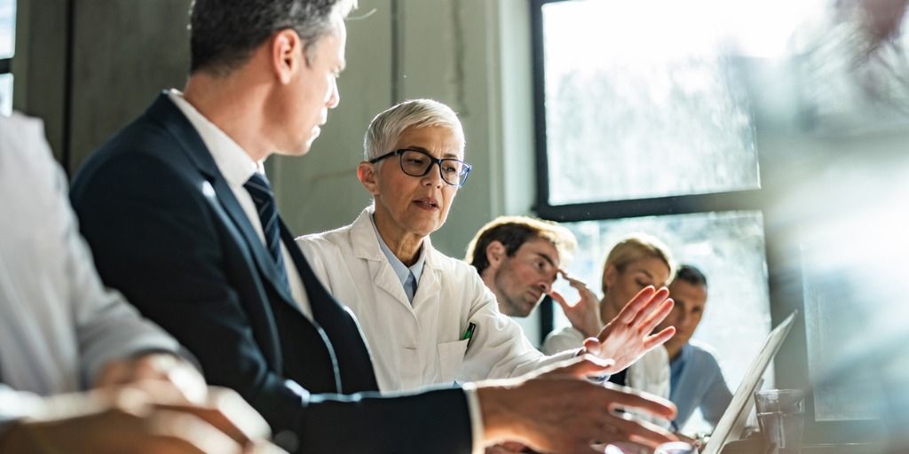 Physician chatting with business executive patient