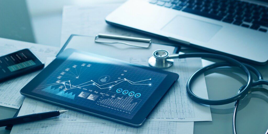 Tablet and stethoscope on desk with advanced test results