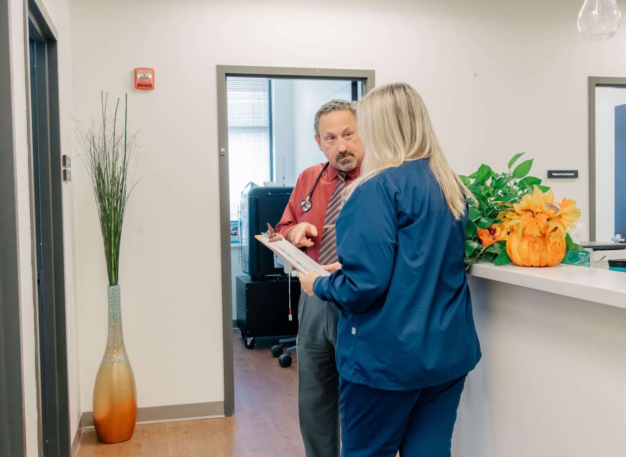 Dr. Eric Carr, concierge doctor in Owings Mills, reviews information with a nurse