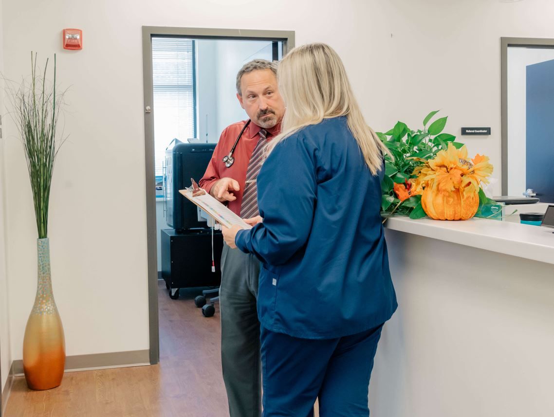 Dr. Eric Carr, a concierge doctor in Owings Mills, talks with a nurse