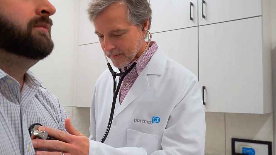 Doctor Brake using his Stethoscope on a Patient