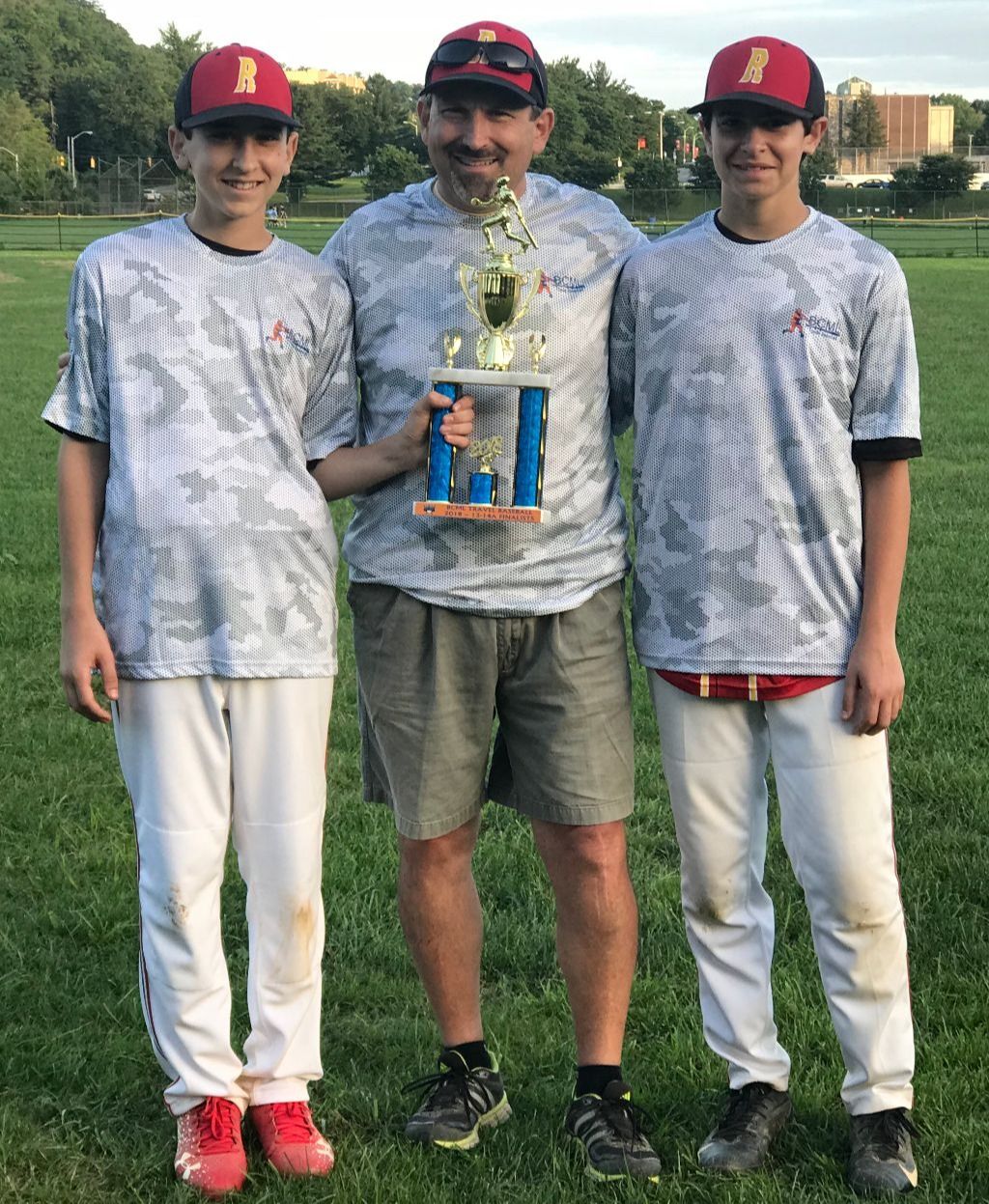 Dr. Carr with his two sons after coaching a baseball tournament. 