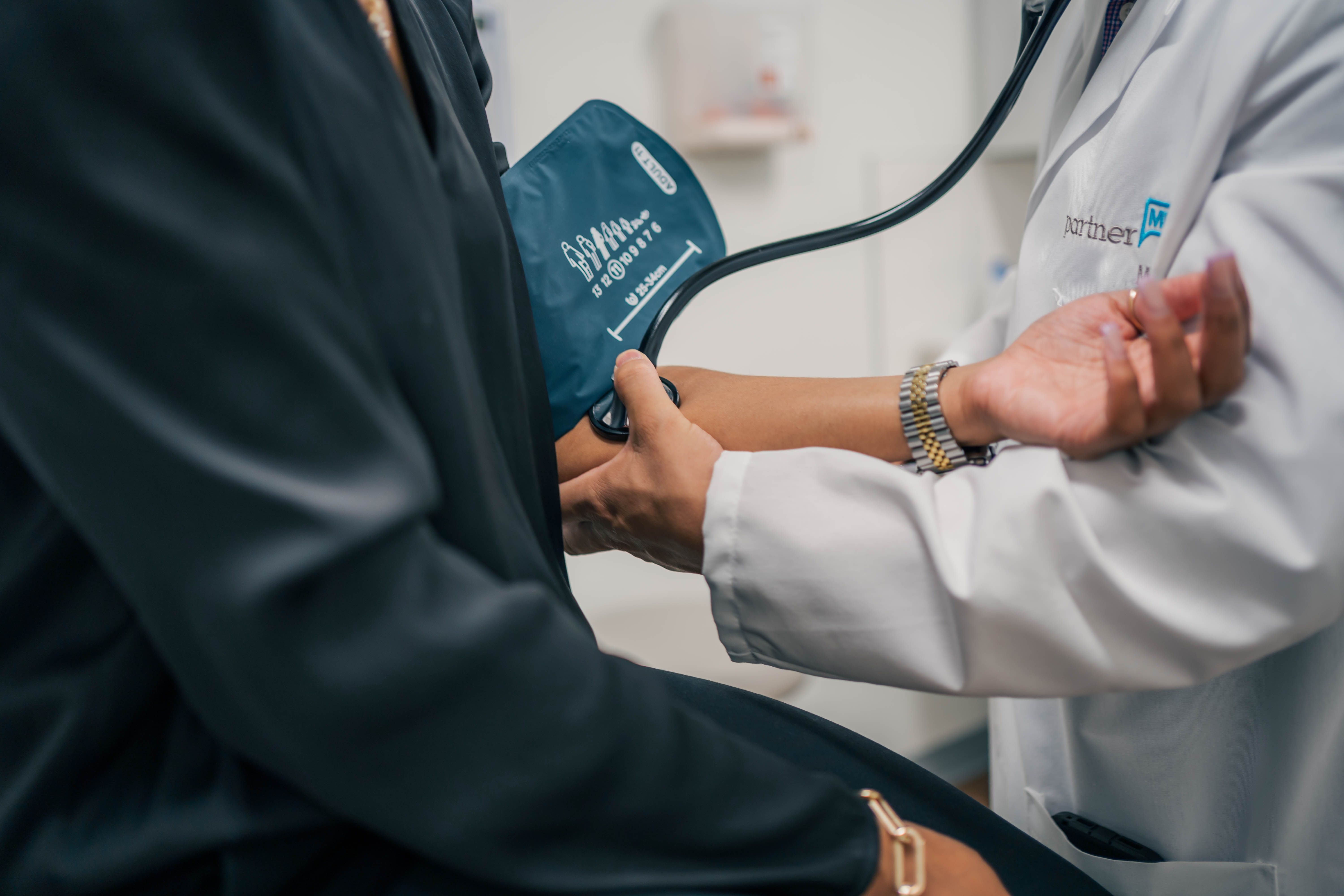 A PartnerMD concierge physician, takes the blood pressure of a patient
