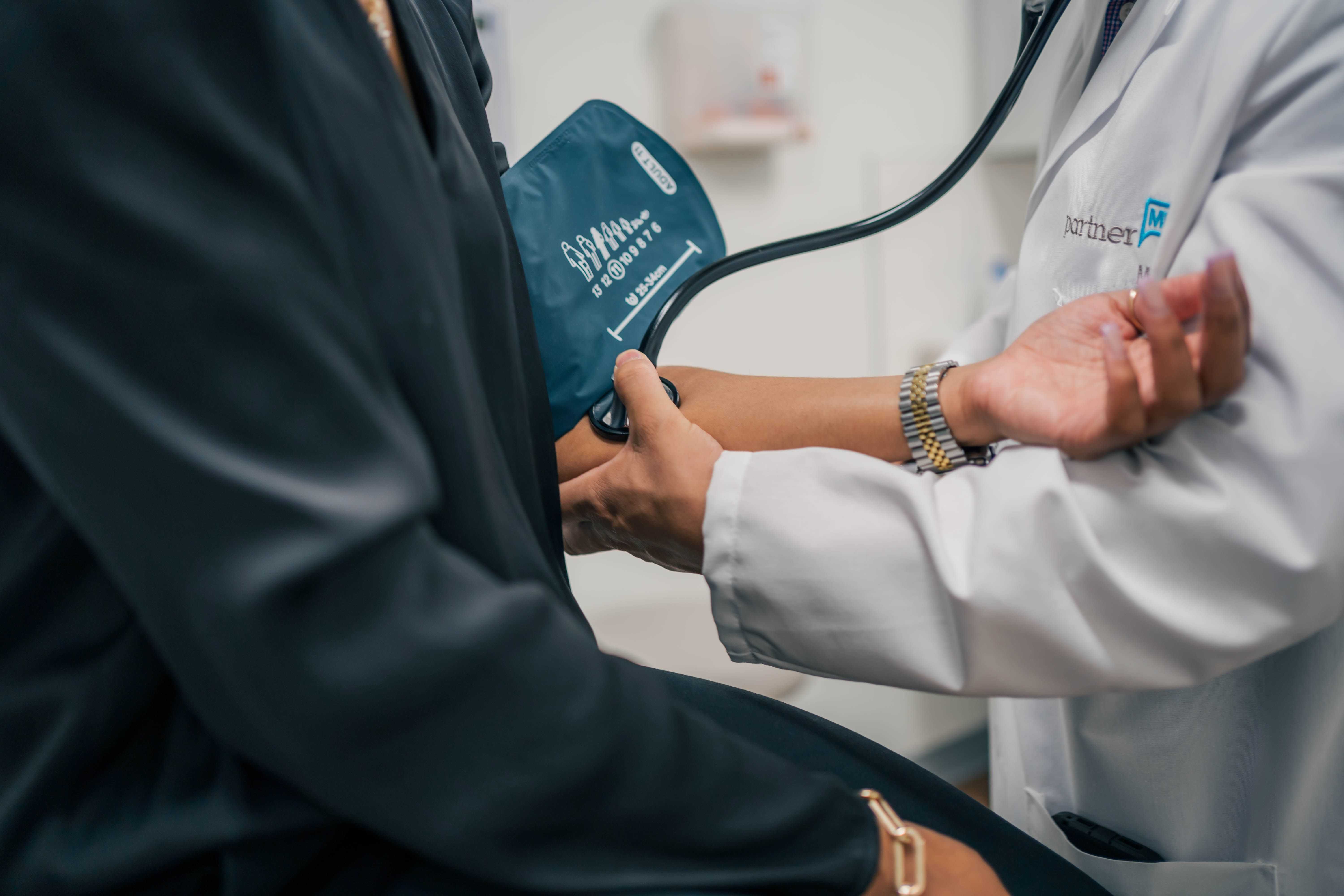 A PartnerMD concierge physician, takes the blood pressure of a patient