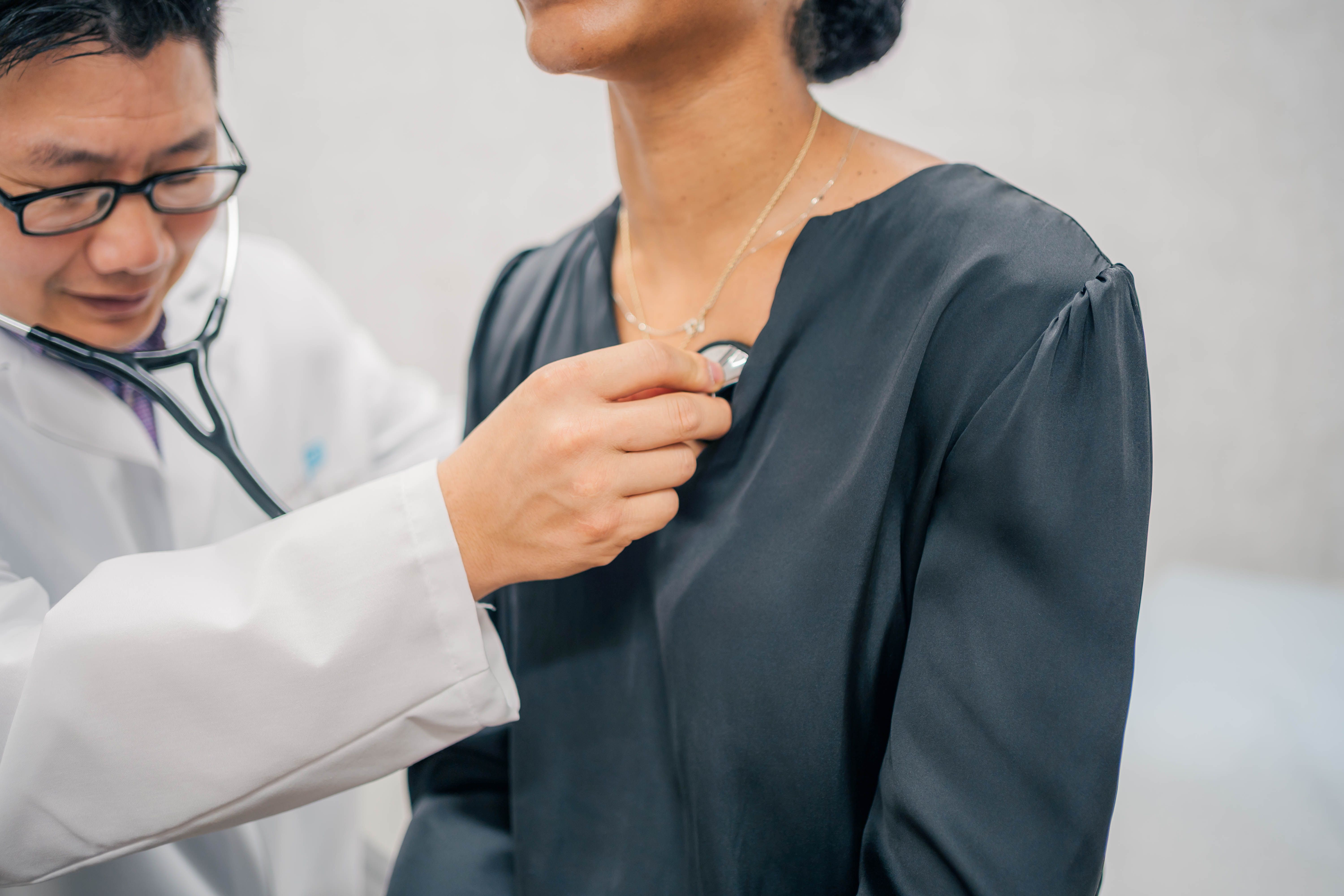 Dr. Roger Shih, a concierge doctor in Richmond, listens to the chest of a patient