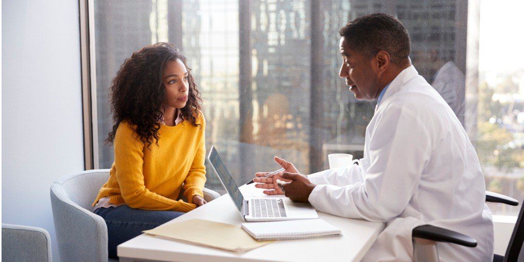 A woman meets with her doctor to discuss if she is right for genetic testing. 