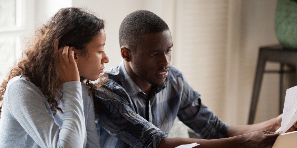 Young couple reviewing genetic test results at home. 