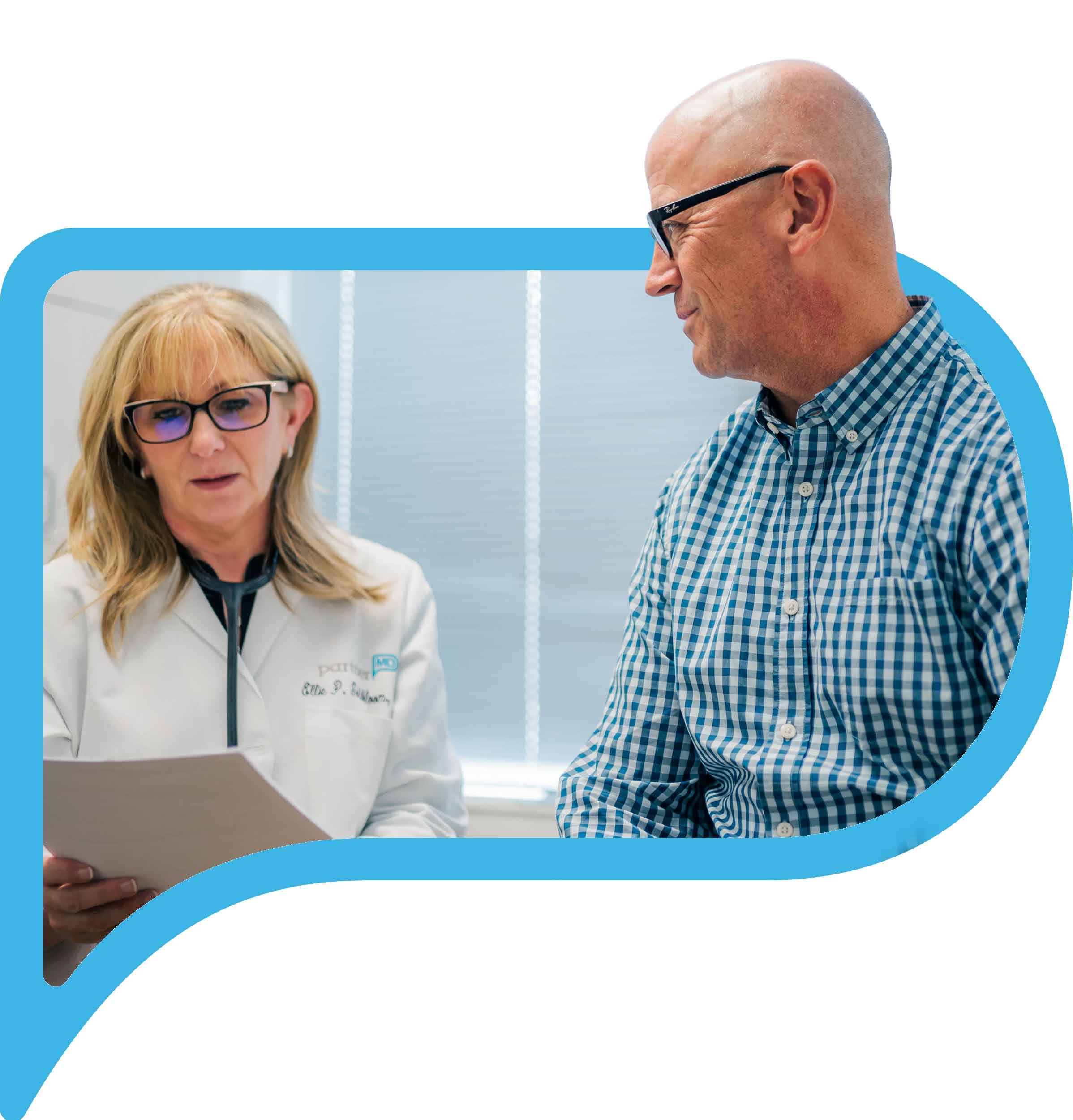 A photo of doctor Goldbloom of PartnerMD Owings Mills going over a chart with a patient.